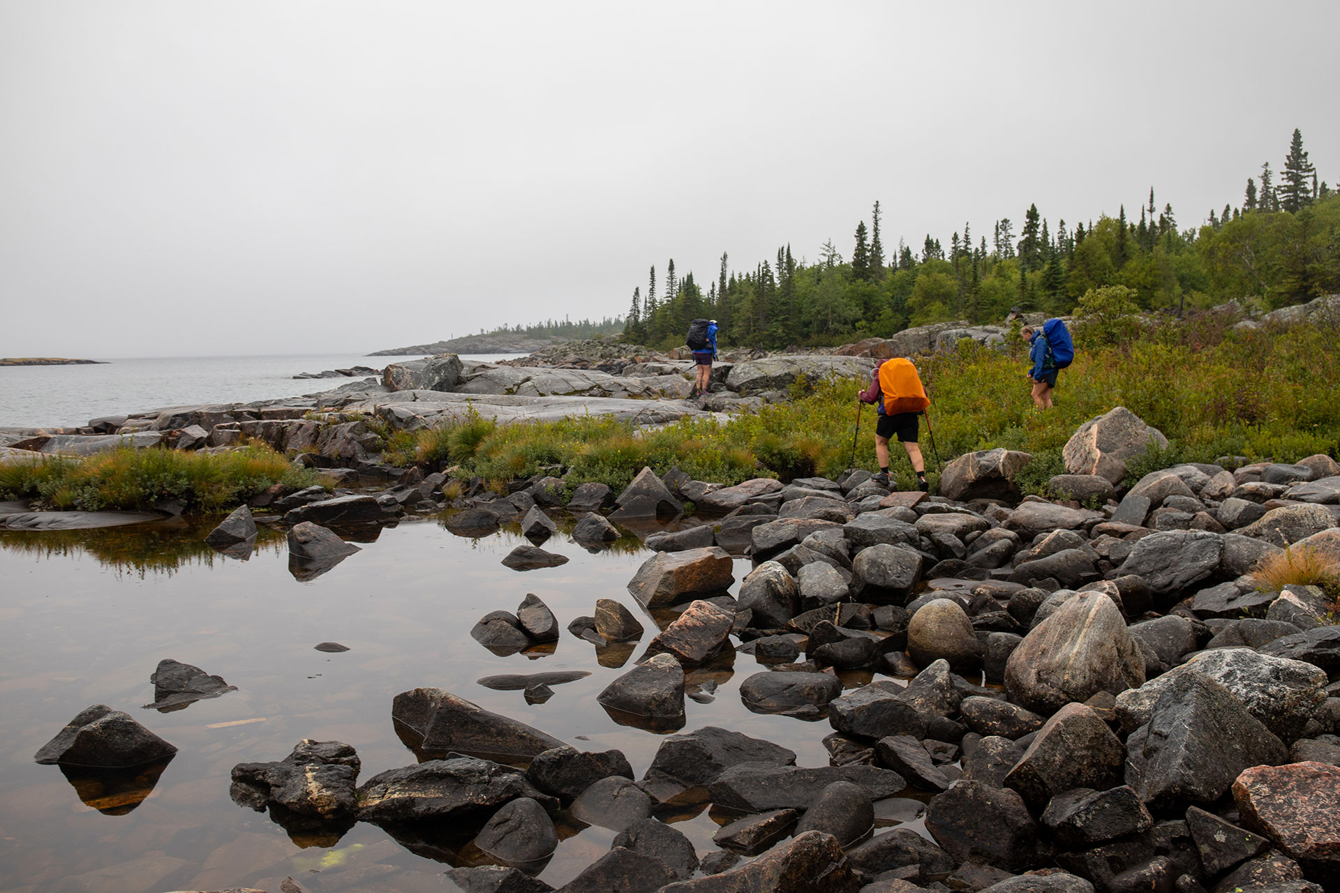 people hike along the Lake Superior coast in Pukaskwa