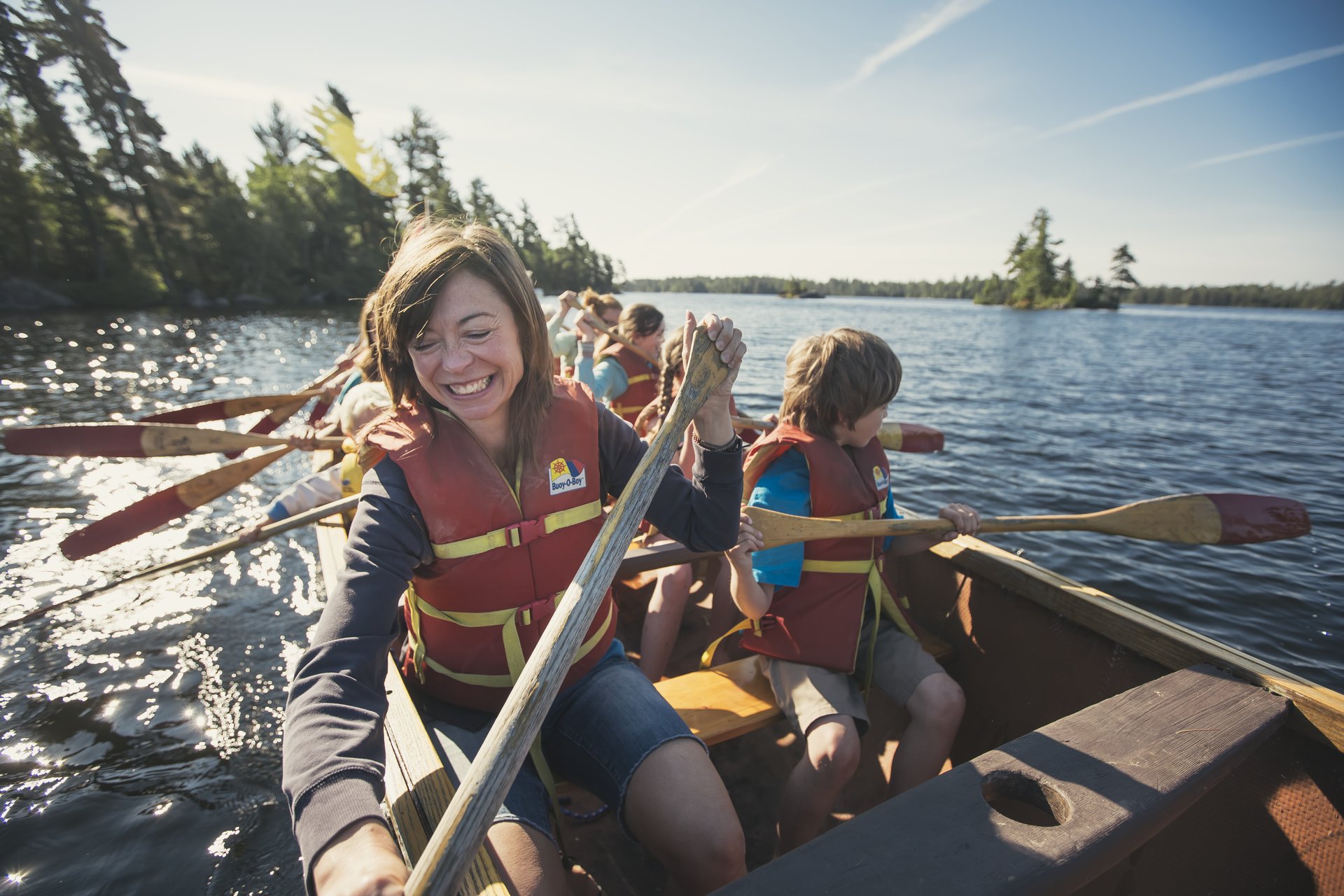 family groups paddle a big canoe in Atikokan