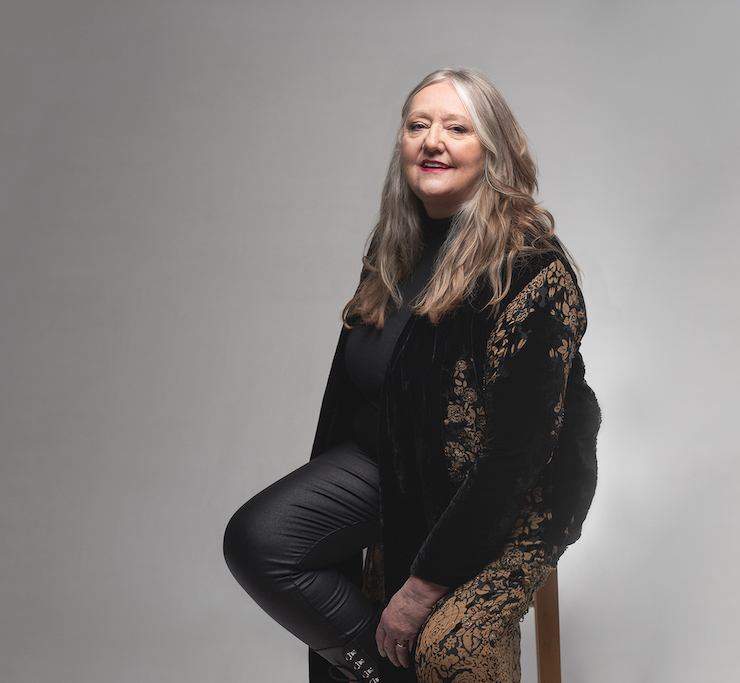 Woman in black sitting on stool