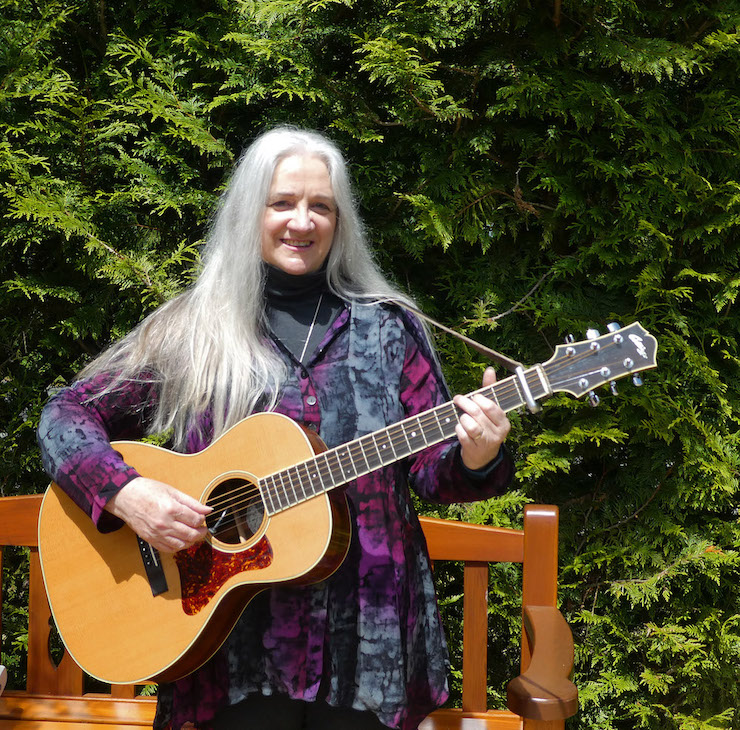 Woman standing with guitar