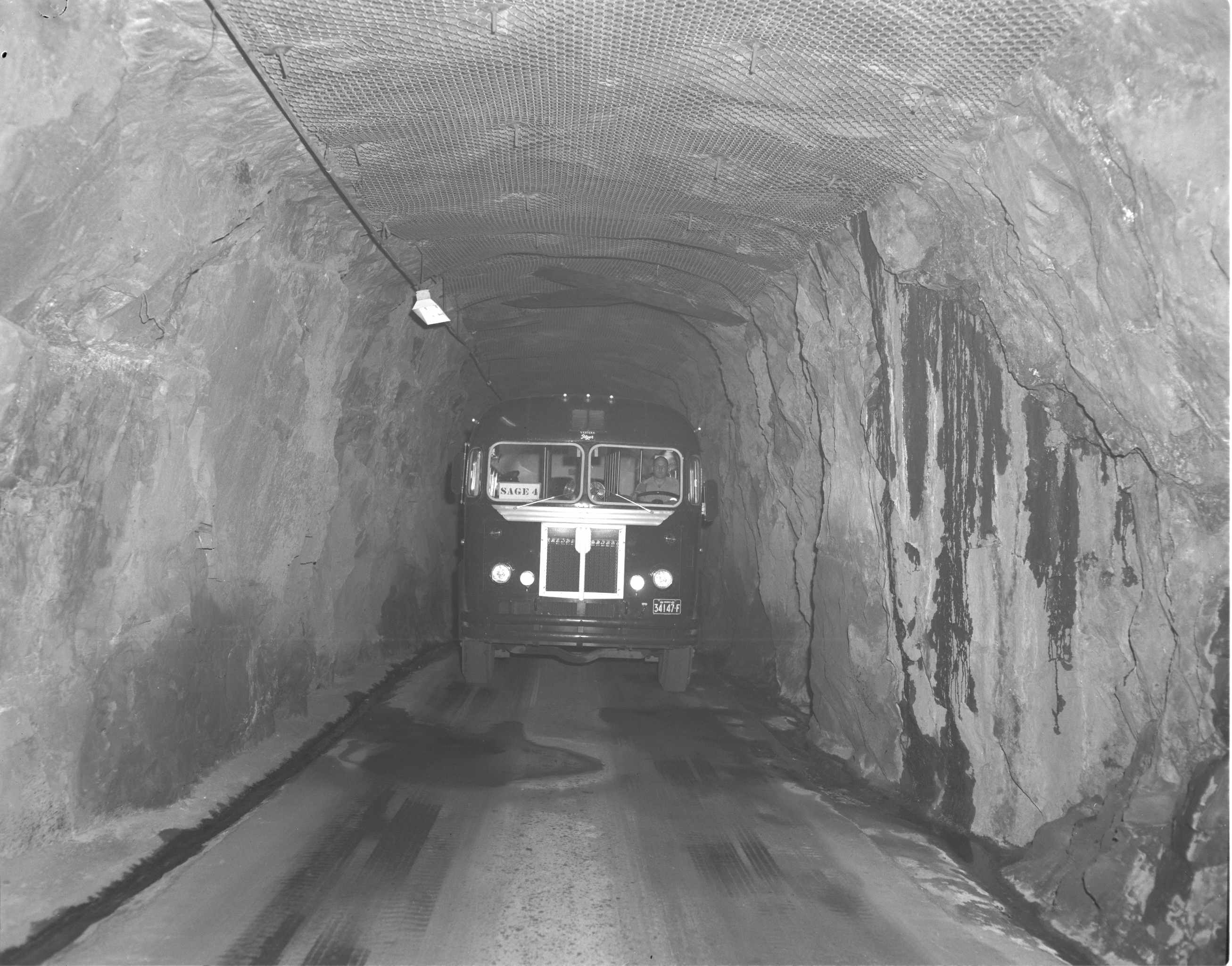 A bus travels down one of two narrow tunnels used to access the NORAD facility 600 feet below the surface.   
