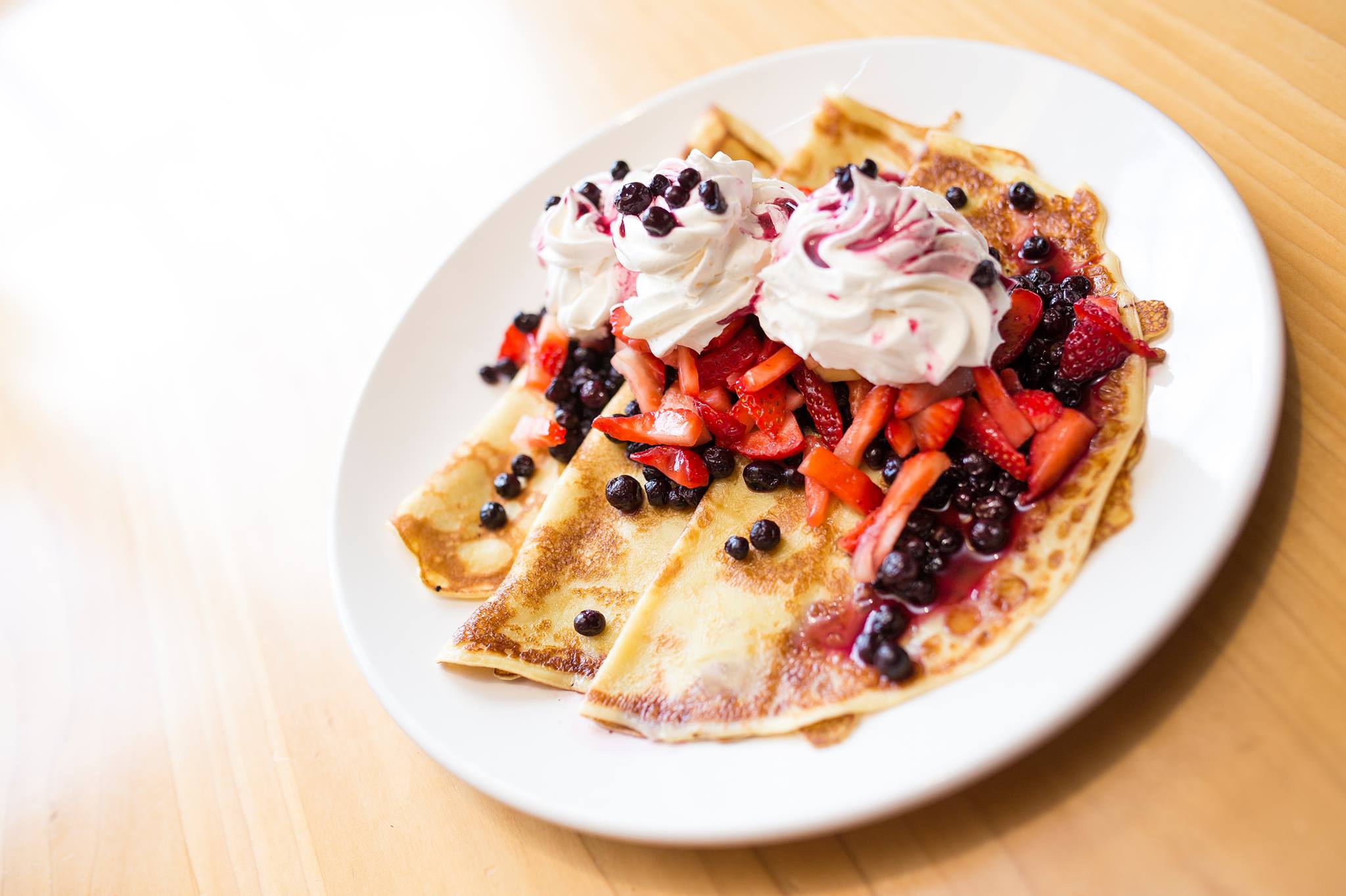 3 Finnish pancakes topped with mixed berries and cream