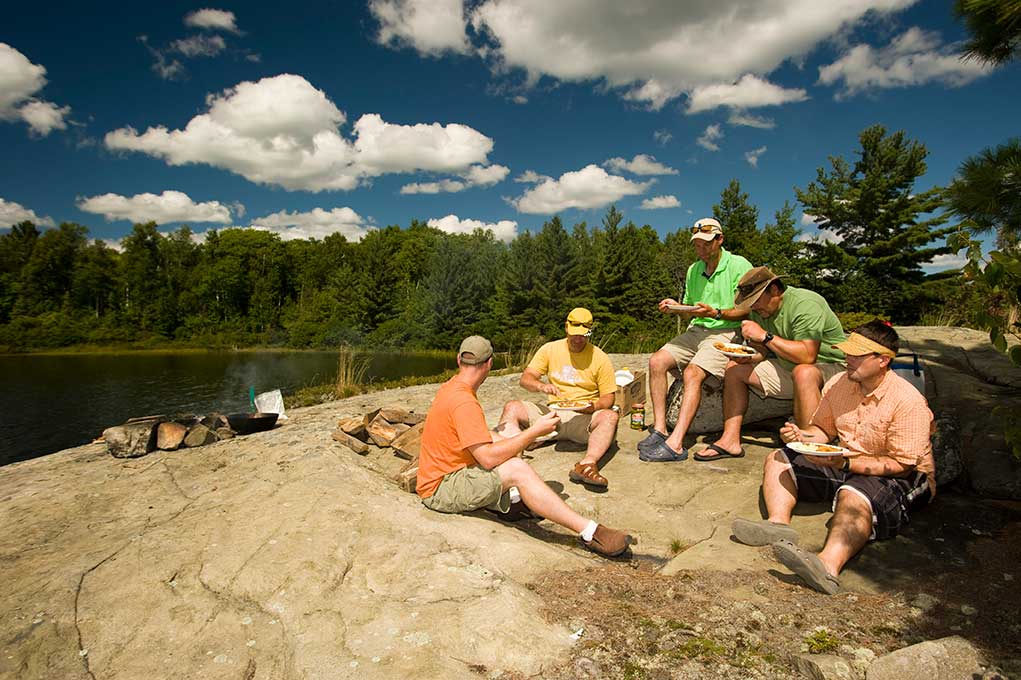 group of anglers eating shore lunch