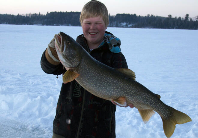 This big sure is happy with his lake trout caught at Smith's Camps