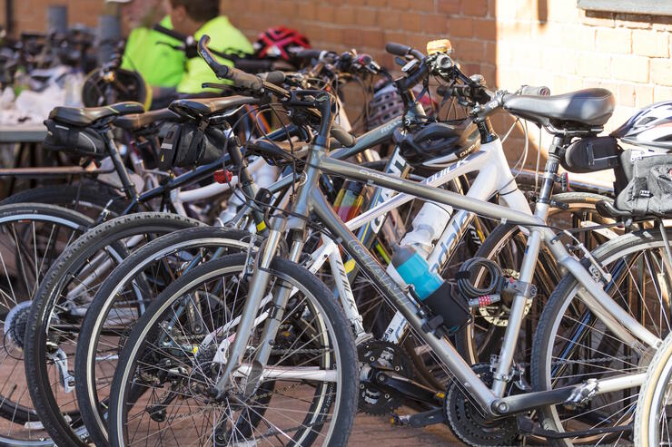 A bunch of bicycles in a bicycle rack.