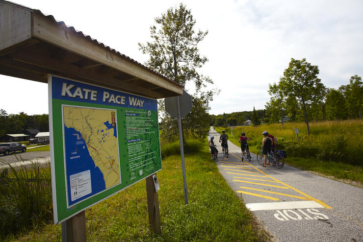 Group of cyclists on a paved bike trail