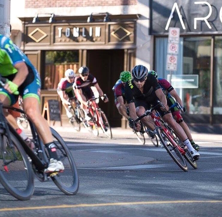 Cyclists riding fast on a downtown street