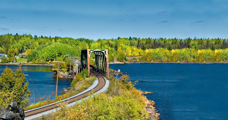 Scenic landscape with train track and bridge over river