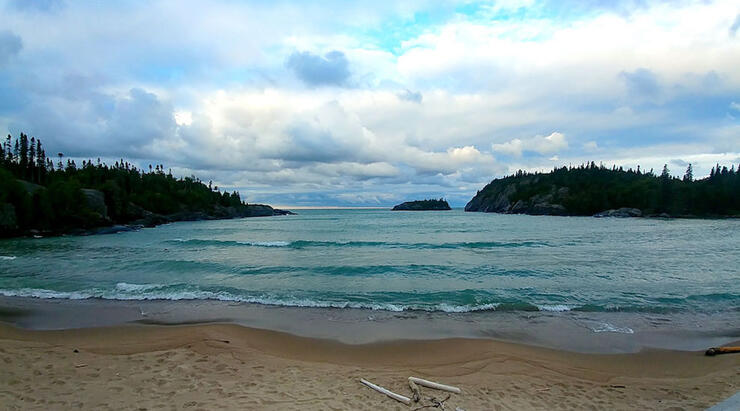 Sandy beach with turquoise water and waves 