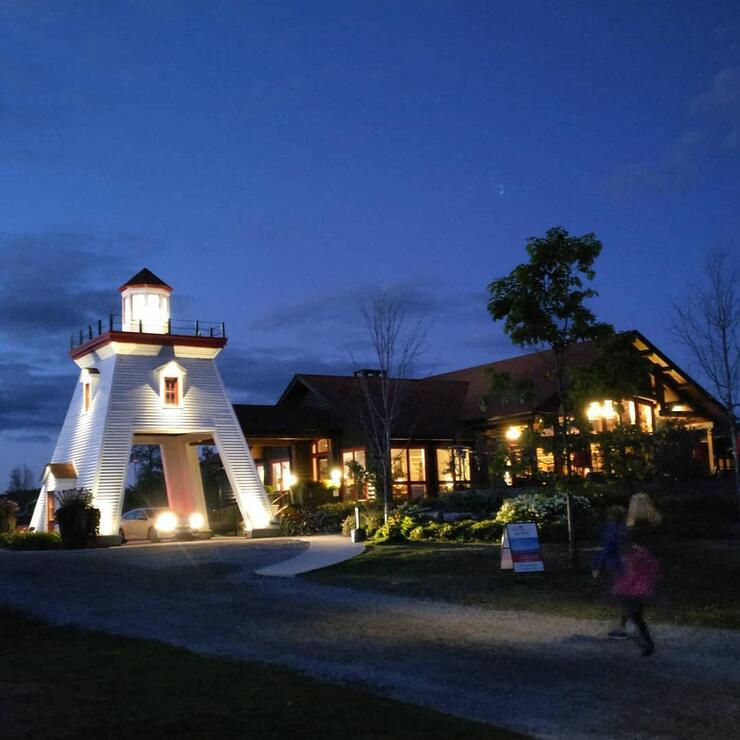 Night image of lighthouse entrance and lodge.