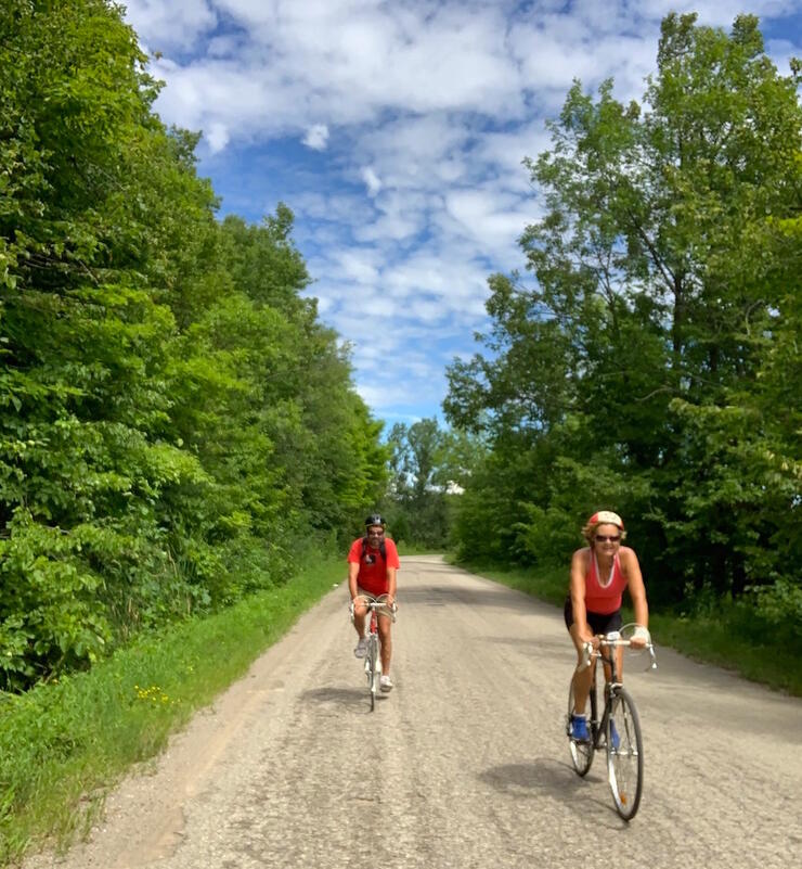 Two cyclists on a gravel country road