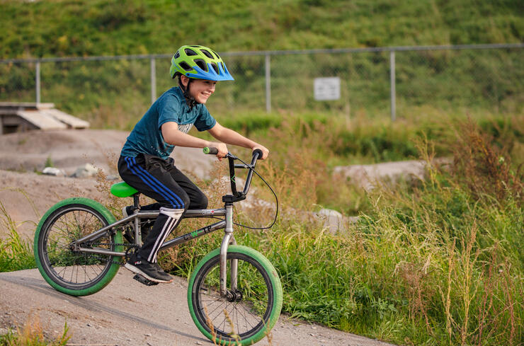 Young boy on a bike on a pump track
