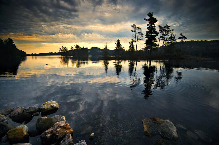 Beautiful view across lake with clouds and sunset reflection