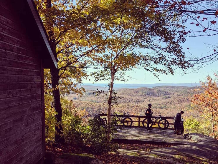 Two cyclists overlooking a scenic view from top of King Mountain. 