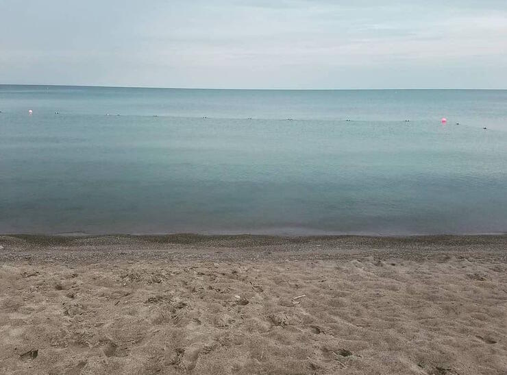 Empty beach in front of turquoise water