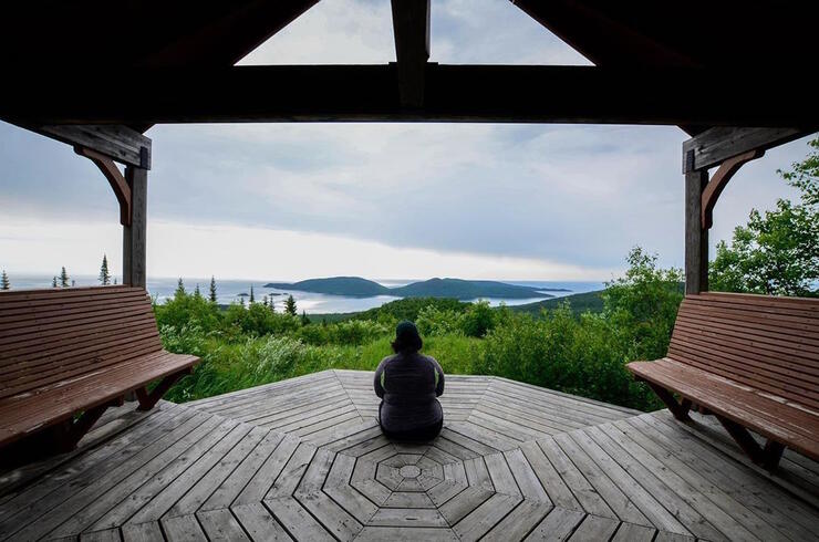 Woman sitting on the floor of a gazebo overlooking Pic Island.