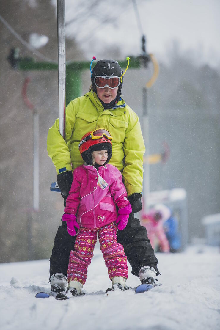 Father and daughter on a ski lift. 