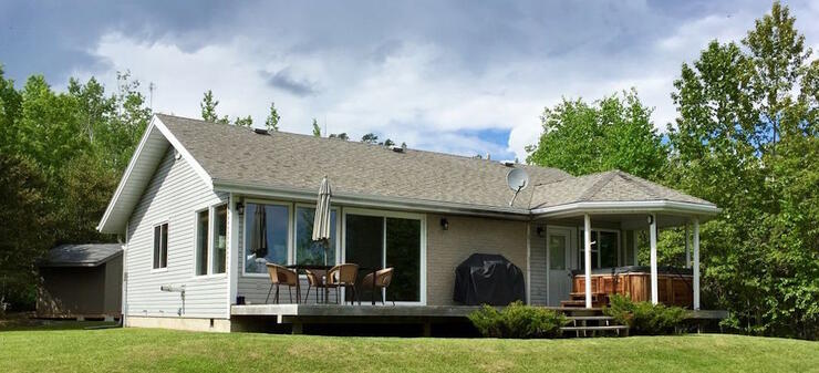 Small bungalow with hot tub on deck.