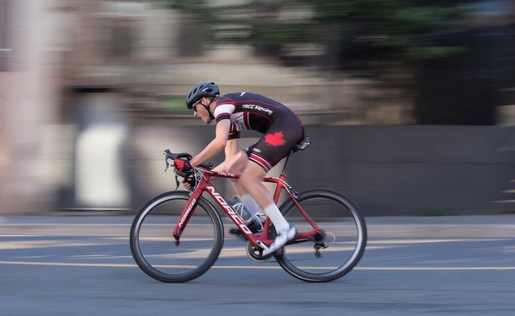 Man speeding along a street on a bicycle
