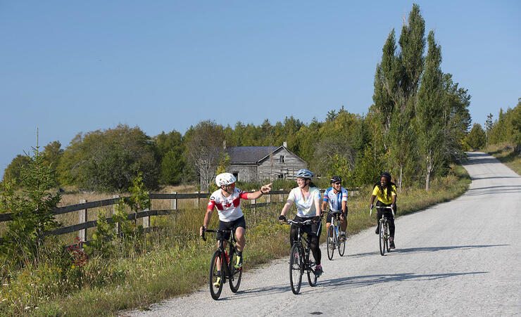 Group of cyclists travelling on a gravel country road