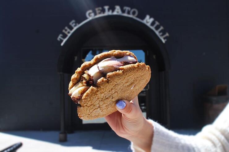 Delicious ice cream between two large cookies.