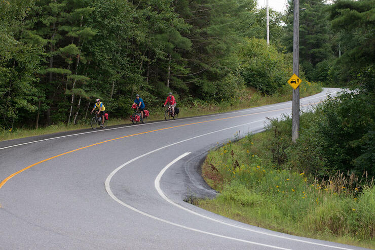 People cycling on a bend in the road