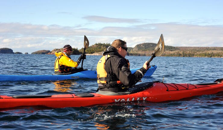 Two kayakers paddling on Lake Superior.