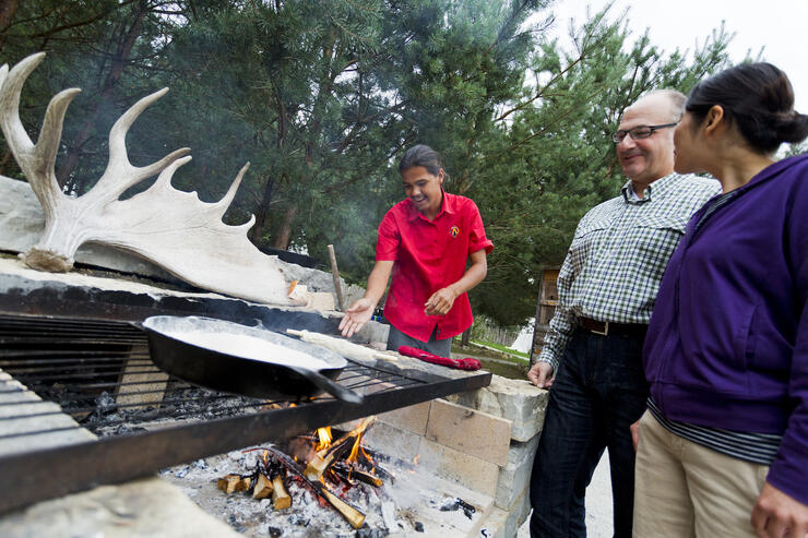 Bannock making over an open fire.