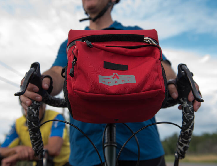 Red bicycle pack on front handle bars.