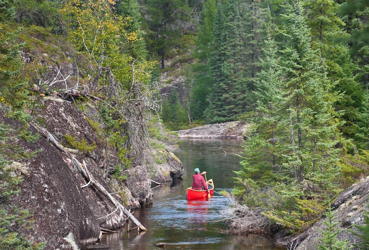 Red canoe paddling down a river
