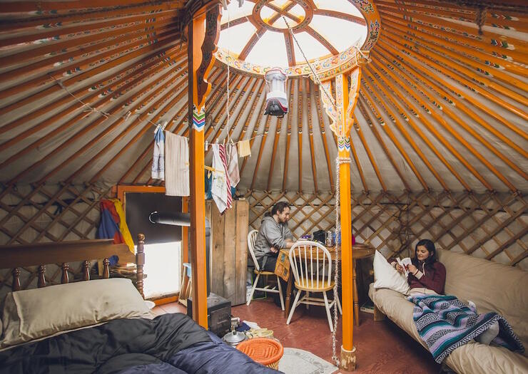 Couple relaxing inside a Mongolian Yurt.