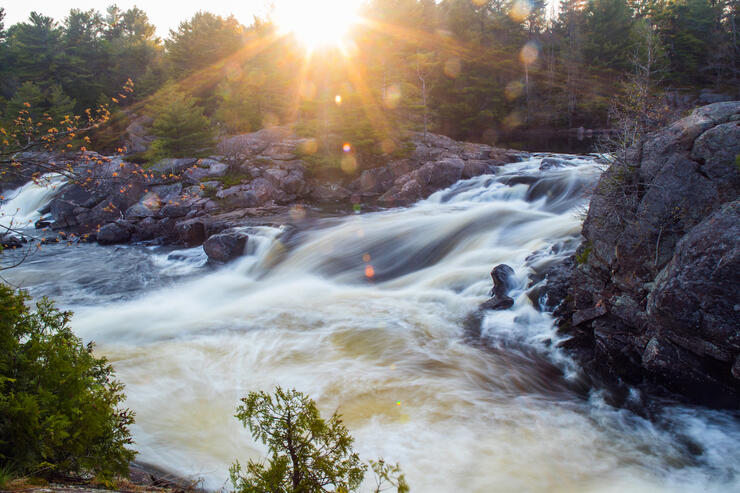 Beautiful waterfalls surrounded by bedrock and trees