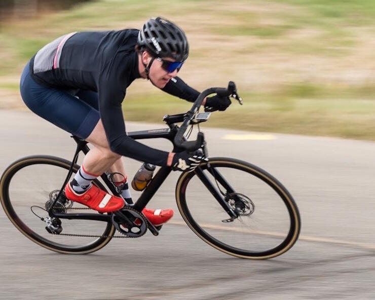 Man on road bike riding hard