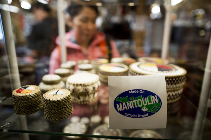 Birch bark quill boxes on a store shelf.