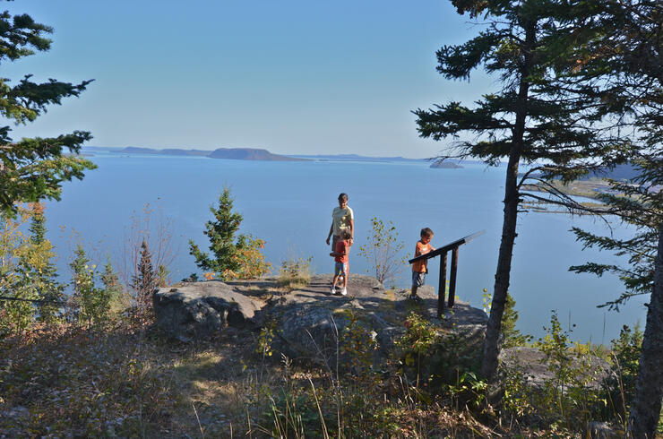 Woman and two children on scenic lookout overlooking Lake Superior