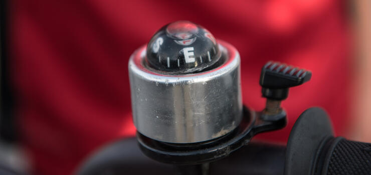 Small compass mounted on bicycle.