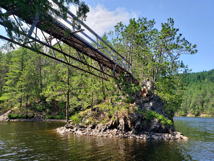 Looking up from the river to a footbridge.