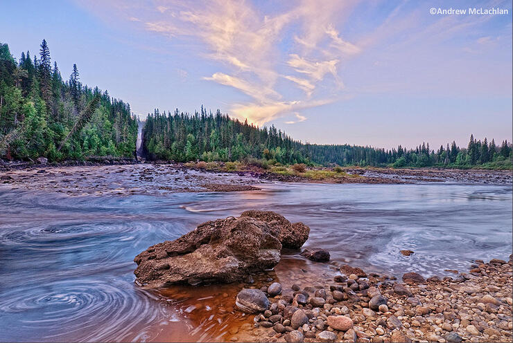 Beautiful view of river, blue sky and forested shoreline