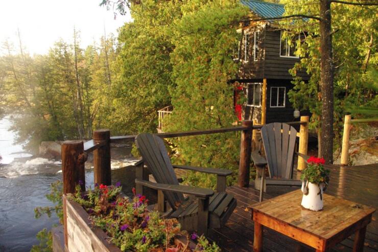 Wooden deck and cabin overlooking waterfalls 