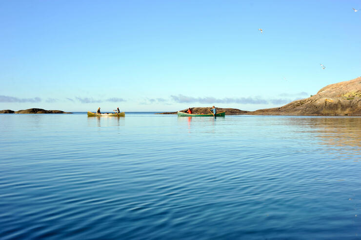 Canoes on calm lake.