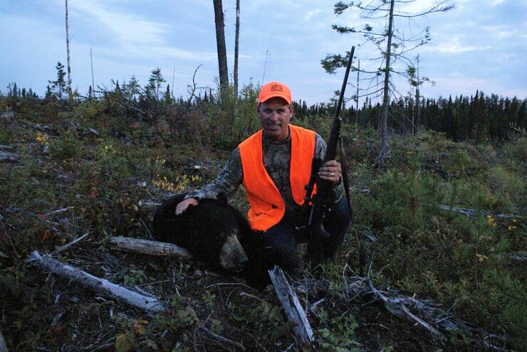 hunter with harvested black bear