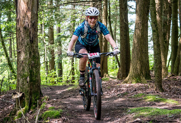 Person on a mountain bike on a forested trail.