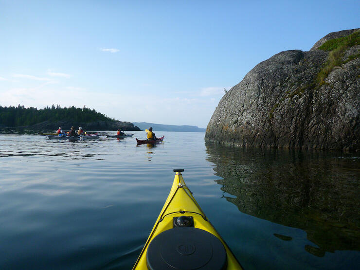 View from kayak of other kayakers on waters of Lake Superior