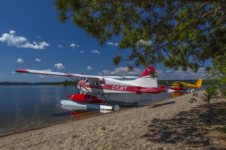 Float plane with canoe strapped on pontoon.