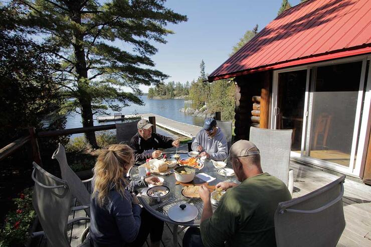 people eating outdoors on patio in wilderness