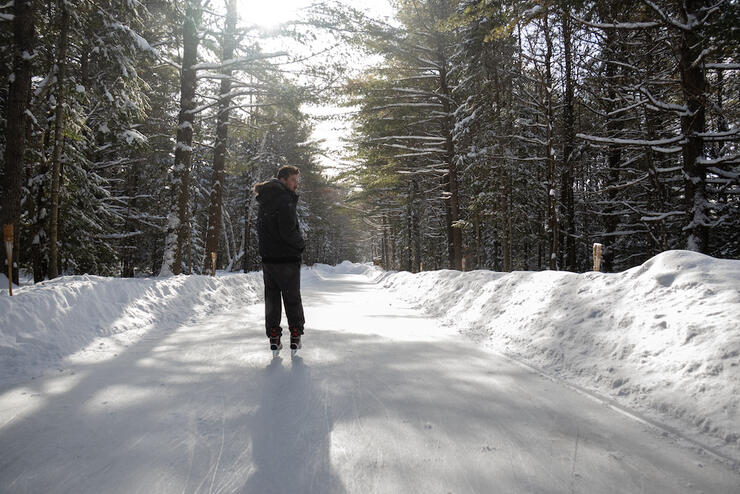 Man on skating trail in the woods