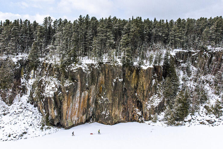 Two people pulling a sled by rick cliff