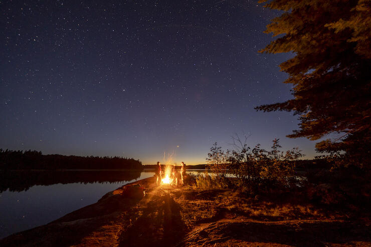 Group of people under a starry sky in Quetico