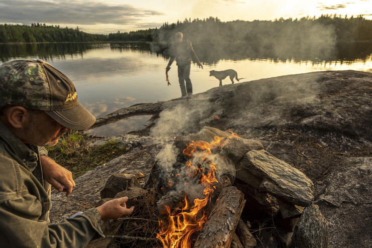 Campfire along the edge of a foggy lake