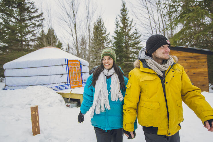 Couple walking in front of a Mongolian yurt